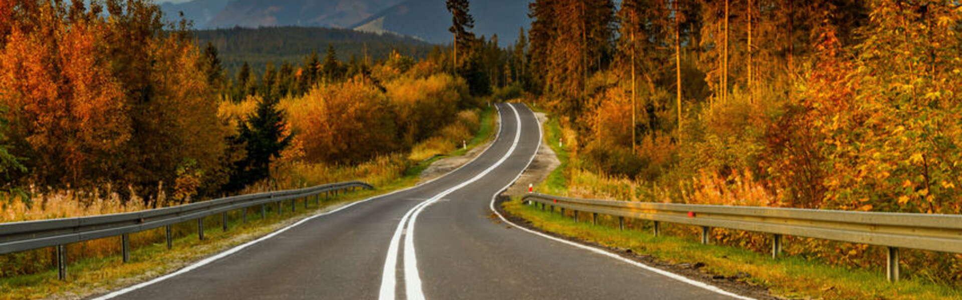 Tarmac road with mountains in the background.